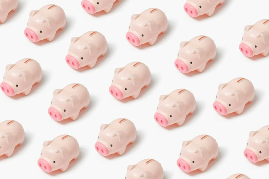 Lots of small pink piggy banks lined up in rows