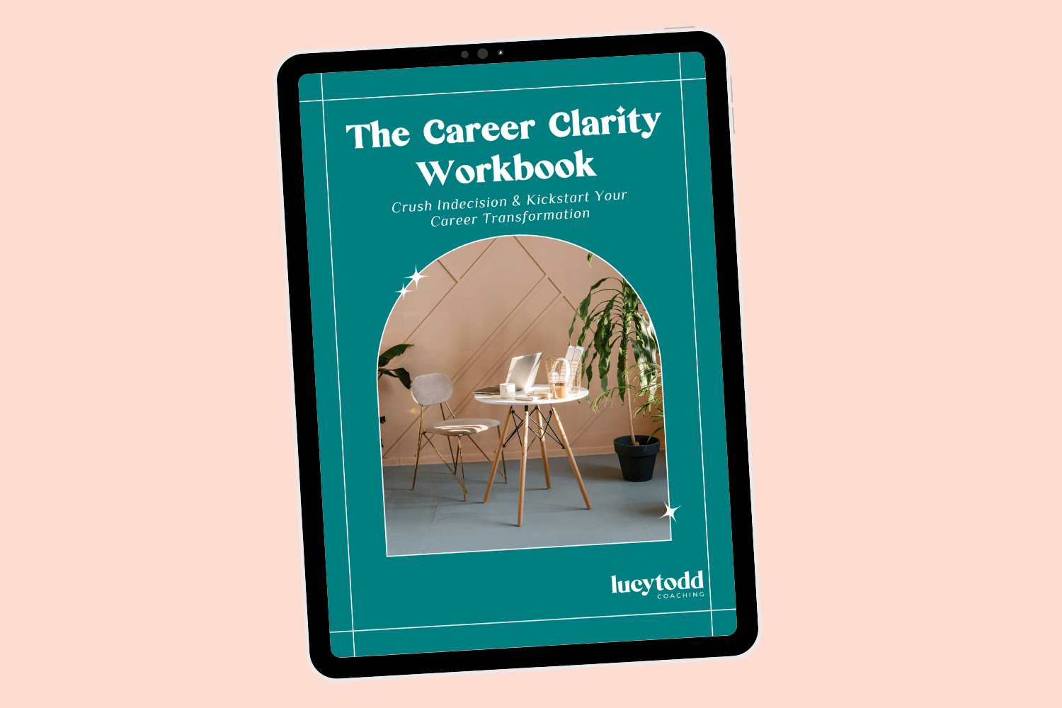 Tablet with page of ebook career transition guide Career Clarity Workbook by Lucy Todd Coaching, featuring the cover with a photo of a white chair and coffee table in a pink room with plants, and a laptop on the table