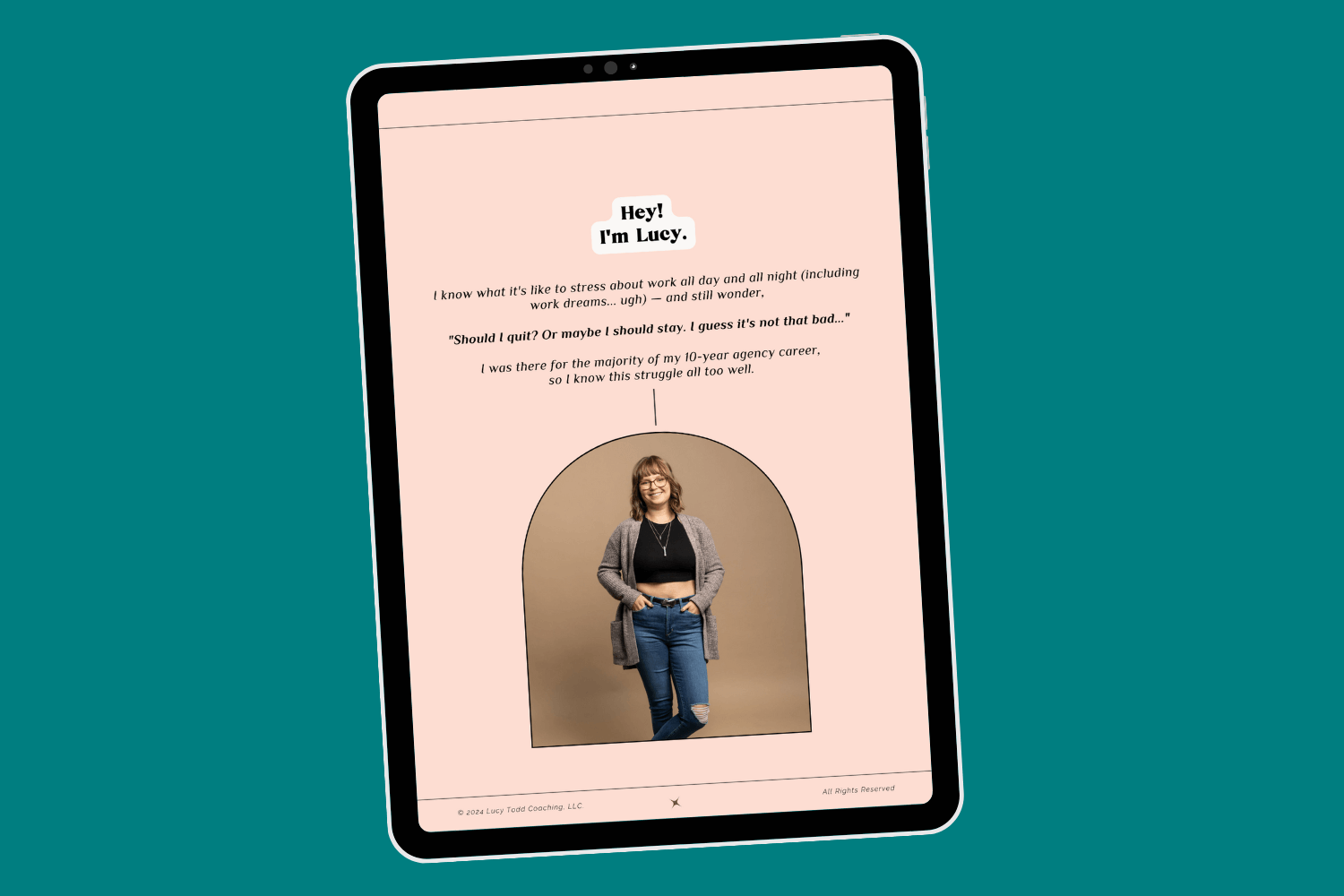 Tablet with page of ebook career transition guide Career Clarity Workbook by Lucy Todd Coaching, featuring a pink page and a photo of Lucy standing with hands in pockets of dark ripped skinny jeans, also wearing a beige cardigan and black cropped tank top. Lucy has bangs, shoulder-length light brown hair, and glasses, and she smiles widely.