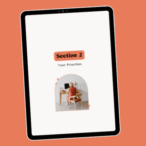 Tablet with page of ebook career transition guide Career Clarity Workbook by Lucy Todd Coaching. The title of the page is "Section 2: Your Priorities" featuring a photo of a young white blonde woman in an orange dress facing away from us, sitting at a desk working on her computer in a naturally-lit white home office space